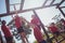 Trainer assisting kids to climb monkey bars during obstacle course training