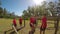 Trainer assisting a school girl in fitness trail during obstacle course 4k