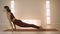 Trainer doing upward facing dog pose. Woman performing yoga poses in studio