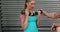 Trainer explaining to woman how to use dumbbells
