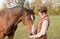 Trainer Feeding Horse