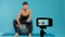 Trainer filming workout video on camera to give fitness advice