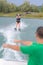 Trainer giving proper holding signal for water ski