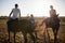 Trainer guiding female friends in riding horse