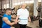 trainer measures the volume, waist, centimeters of the body. An elderly woman lost weight in the gym, classes and