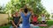 Trainer and seniors performing yoga in garden 4k