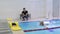 Trainer show exercise with noodle to eldelry woman in swimming pool