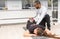 Trainer stretching calf of woman in gym