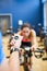 Trainer timing woman on exercise bike