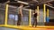 Trainer by trampolining is teaching young woman to jump in a gym