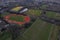 Training field with tall goal posts for Irish National sport, camogie, hurling, rugby, Gaelic football. Running track with red