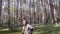 Training fighter with a knife in the woods. Cool guy with long hair and beard trains with a knife.