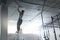 Training At Gym. Female Crossfit Athlete Climbing Rope