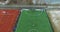 Training junior football team on the sports ground with a green lawn in winter day