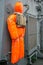 A training mannequin hangs on the wall of a warship.