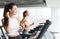 Training with music. Girl doing cardio exercise on treadmill