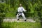 Training in nature. A karate trainer is wearing a white kimono. Black belt in karate