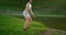 Training in the Park of a woman performing squats and jumps on the background of the river in the Park. Do sports in the