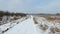 Training sled dogs on rural road in winter