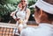Training tennis together. Cropped image of girl player and her coach practicing on a tennis court. Female tennis trainer gives a