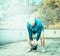 Training on the terrace of the house, overlooking the forest, young man with a beard lifts weights