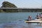 Training of young rowers on the Guadalquivir River in Spain.Launching the boat on the water under the guidance of a coach