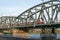 trains of austrian railways travel over the railway bridge over the danube. passenger express