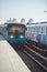 trains at outdoor subway station with buildings