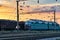 Trains and wagons, railroad infrastructure, beautiful sunset and colorful sky, transportation and industrial concept