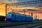 Trains and wagons, railroad infrastructure, beautiful sunset and colorful sky, transportation and industrial concept