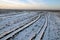 The trajectory of the way an a plowed field and covered with snow