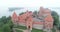Trakai, Lithuania: medieval gothic Island castle, located in Galve lake and town in the background. Aerial above summer