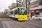 A tram car passing Machiya station rail crossing in Tokyo, Japan