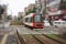 A tram car passing Machiya station rail crossing in Tokyo, Japan