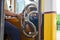 The tram driver holds a helm in a old famous yellow tramway