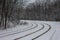 Tram line rails in the snow-covered forest in Kyiv. Ukraine