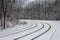 Tram line rails in the snow-covered forest in Kyiv. Ukraine