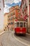 Tram on narrow street of Alfama, Lisbon