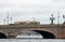 A tram rides on a stone bridge over the Neva river in Saint Petersburg, Russia