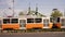 Tram slowing down and passing a bridge in the city