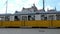 A tram slowly passes through Kossuth Lajos Square with The Hungarian Parliament Building in the background