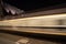 Tram trails on the street of Ghent and monumental column architecture in background, long exposure, blurred motio