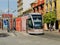 Tram Waiting at Tram Stop in Seville, Spain, with Tourists in Background