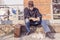 Tramp eating bread sitting in landfills