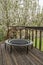 trampoline for fitness exercising and rebounding in a backyard patio, springtime scenery