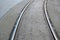 Tramway rails on grey asphalt,stone ground.