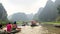 Trang An, Vietnam, Feb 15 2018 - Unrecongnisable people take boat on river at Trang An at Ninh Binh, Vietnam, Full HD