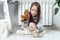 Tranquil adorable little girl sit near heating radiator and playing with stuffed soft bear, rabbit toys, games on floor