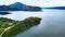 Tranquil Aerial Footage Displaying the Serene Serenity of a Great Lake and Majestic Hills, with Visible Roadways Completing the