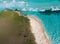 Tranquil aerial shot of a Caribbean beach, amazing view of green grass and light blue water